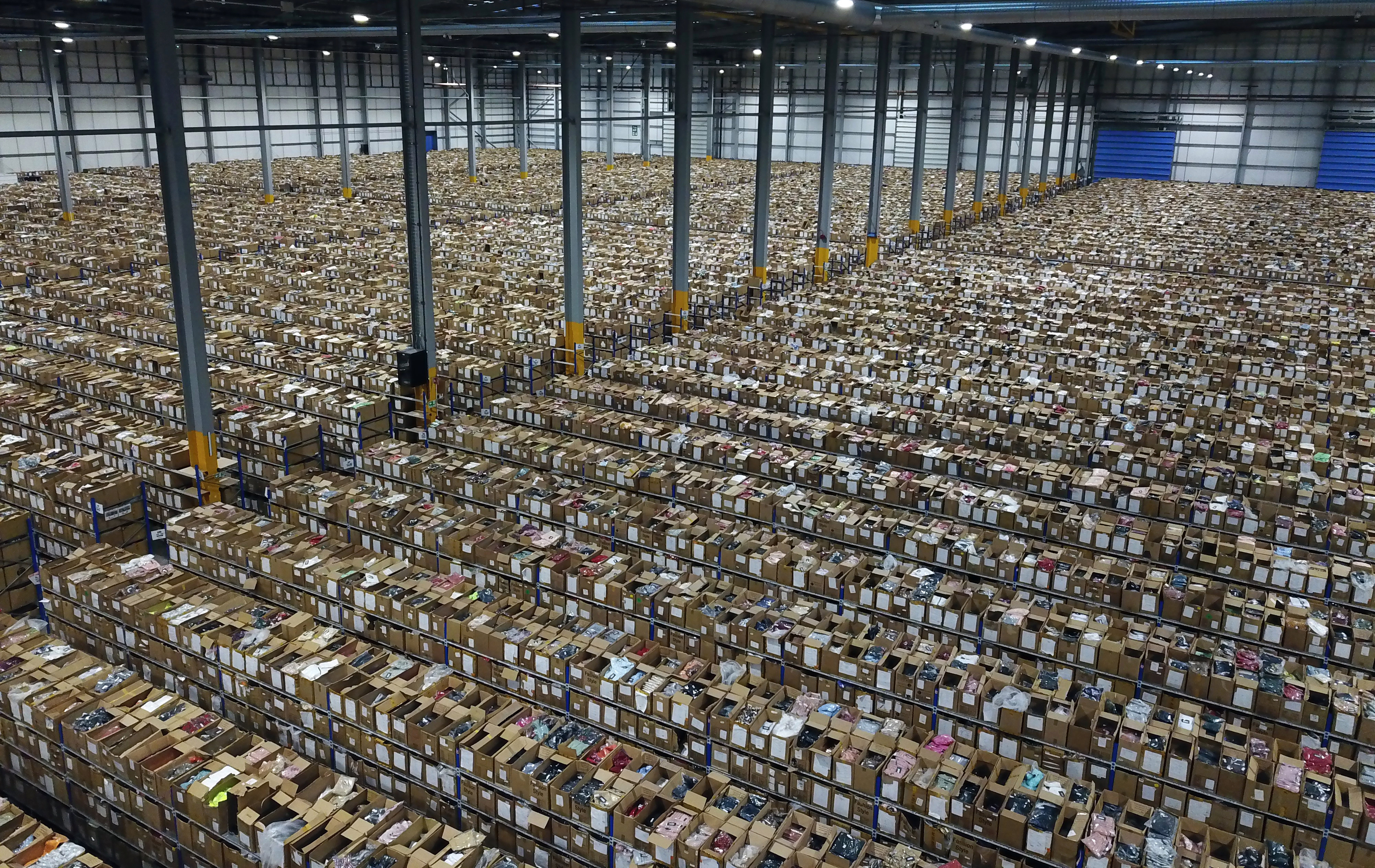 A startling picture from inside the mega-warehouse of clothing brand PrettyLittleThing — the size of 15 football pitches — showing 3,000 workers piling a million orders into boxes ahead of the Black Friday sale