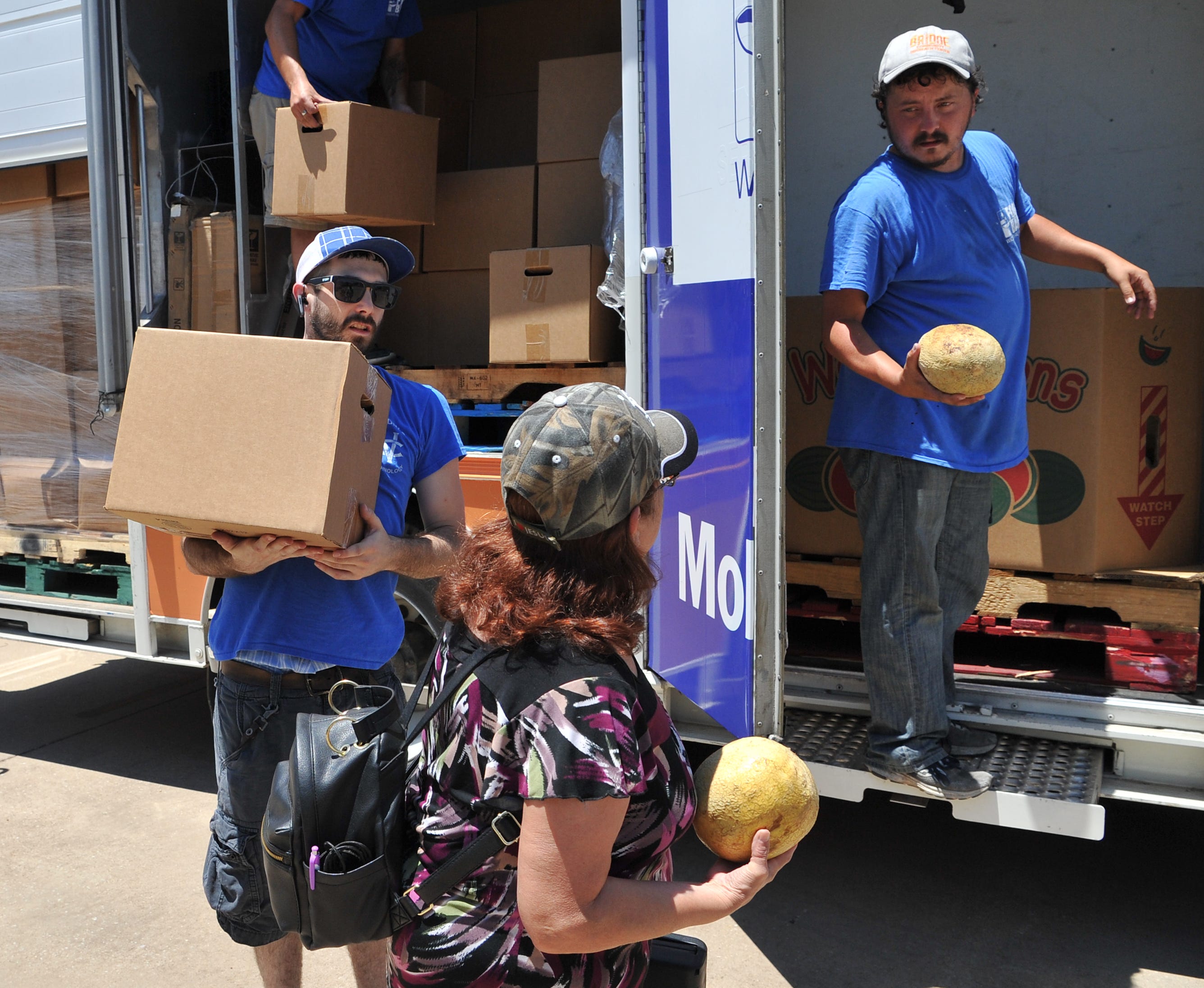 In this file photo, Wichita Falls Area Food Bank Mobile Pantry driver, Mason Sparks, left, and volunteer Justin Black help distribute food from the food bank's mobile pantry.