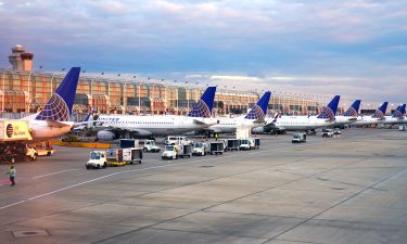 Planes lined up along runway at Chicago O'Hare International Airport