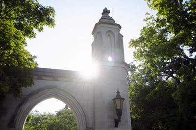 The sun peeks over Sample Gates.