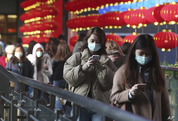 People wear face masks and walk at a shopping mall in Taipei, Taiwan, Jan. 31, 2020.