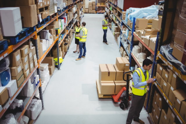 freepik/Warehouse worker using hand scanner in warehouse