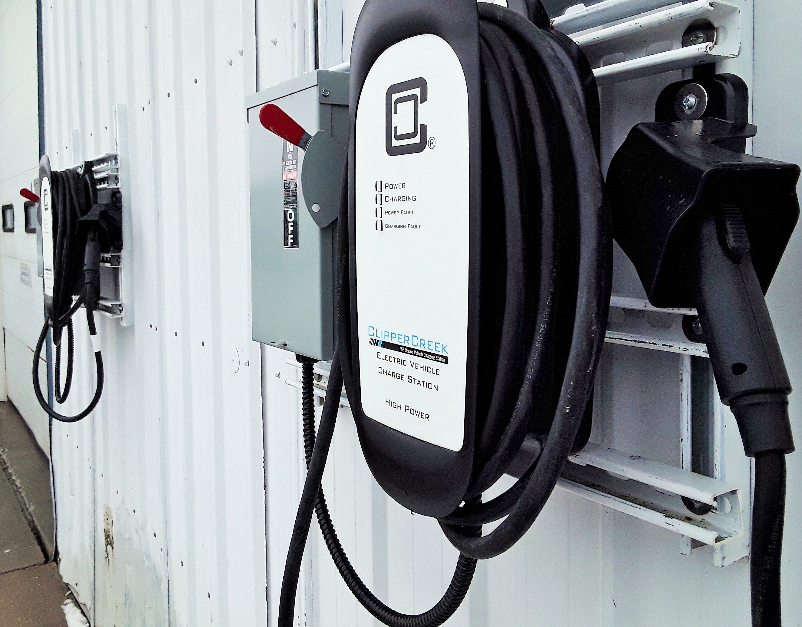 Two electric-vehicle charging stations can be seen on the wall of the Moxie Solar building, home of the new VERV dealership in North Liberty. Moxie employees are said to be test-driving electric vehicles for VERV.