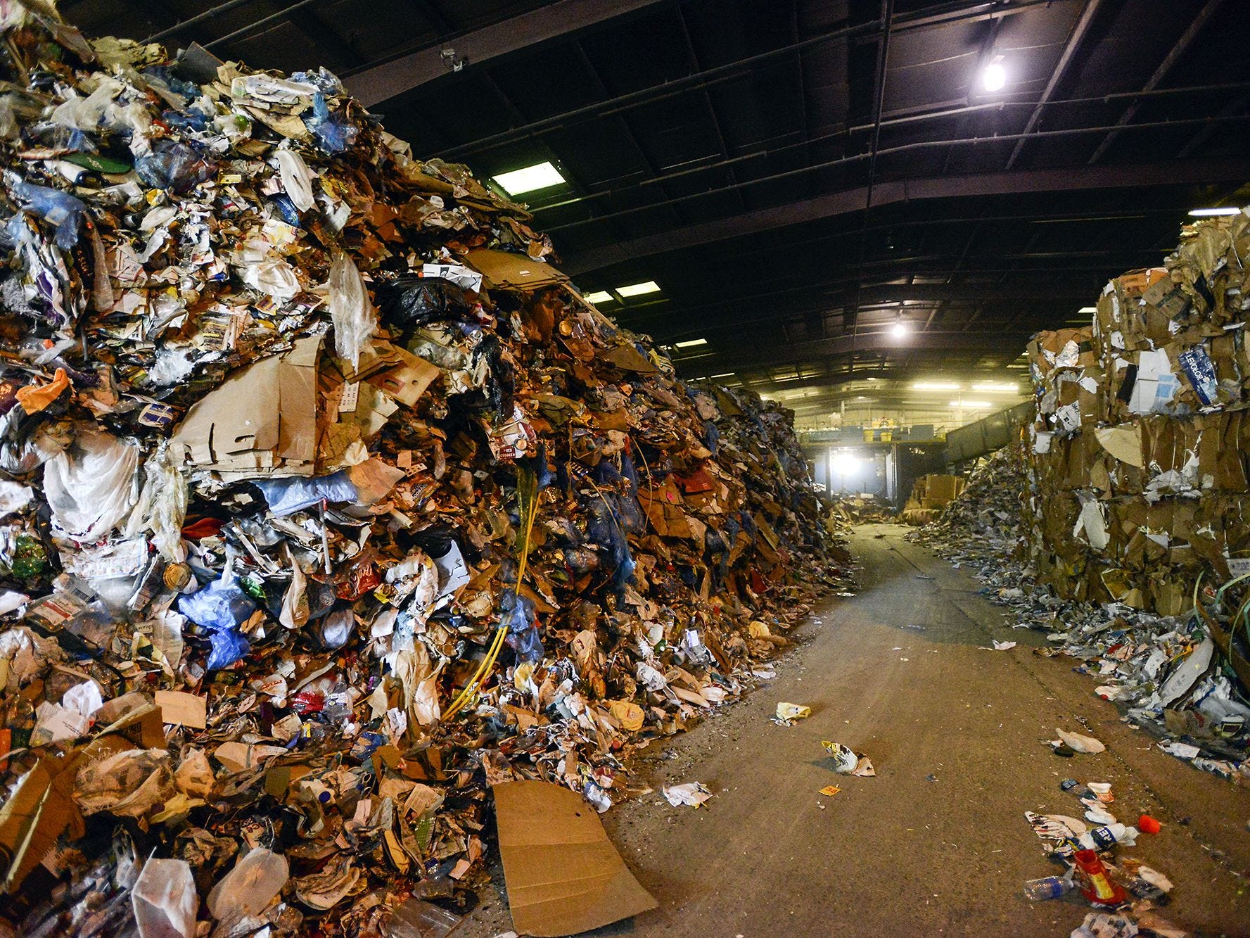 In this file photo, piles of plastic, glass, aluminum and cardboard sit inside the Curbside Management recycling center in Woodfin, in August 2014. Curbie, handles recycling for the city of Asheville and its 30,000 customers, as well as for Fletcher, Woodfin and Weaverville. The piles represent about three days worth of recycling for the center, said president and founder Barry Lawson.