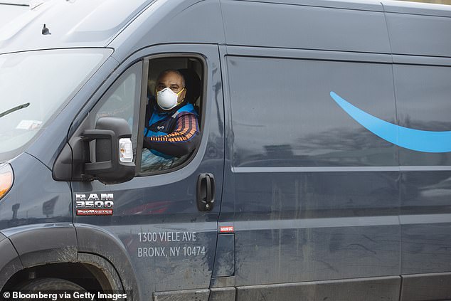 A driver wears a protective mask while traveling in an Amazon.com Inc. delivery truck in New Rochelle, New York