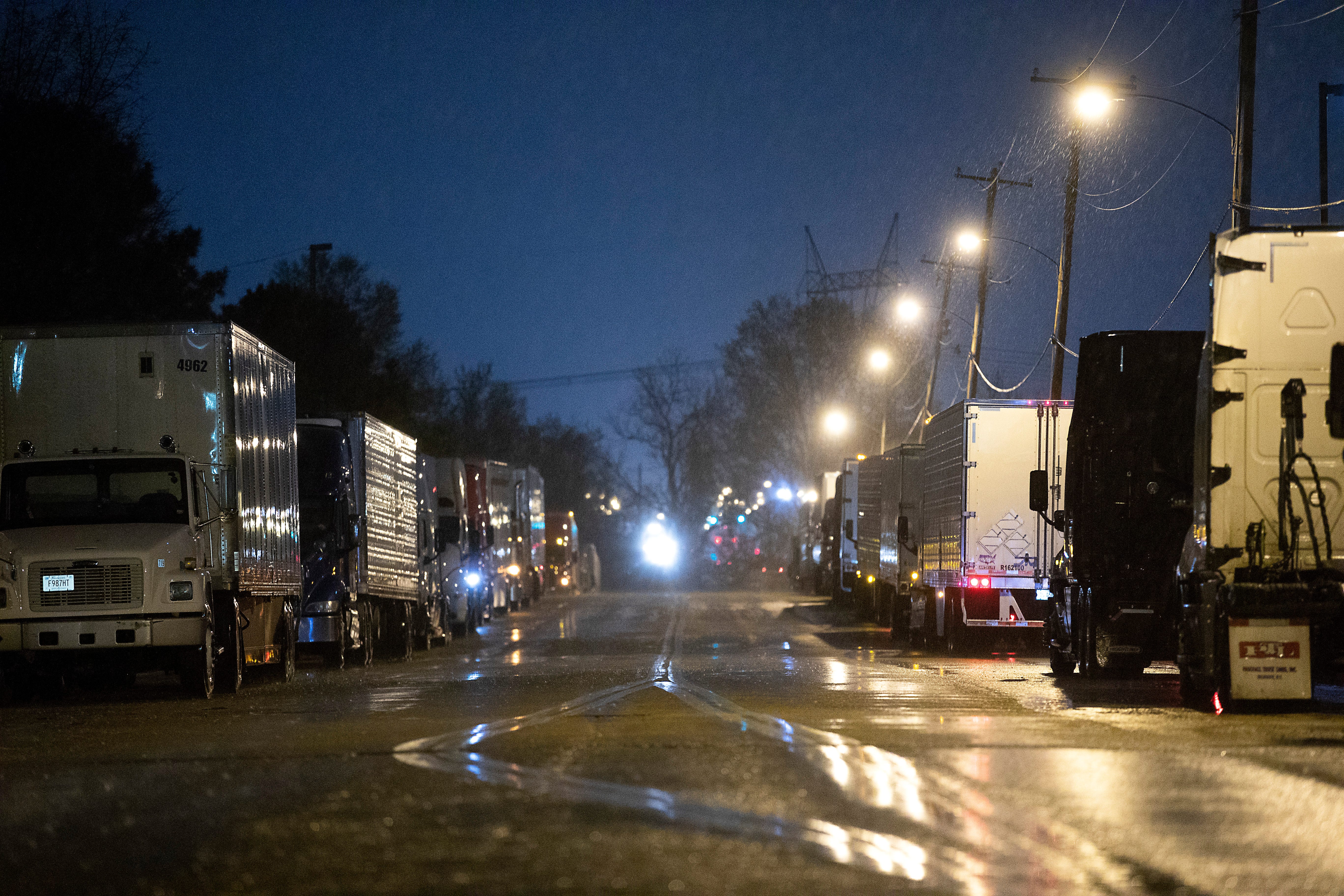 Semi-trucks line up around Kroger supply warehouse on a rain-soaked Tuesday morning where workers are on mandatory overtime, working seven days a week for as much as 16 hour shifts to feed the Mid-South supply chain of grocers as shoppers continue to stock up, cleaning out store shelves around the country. 