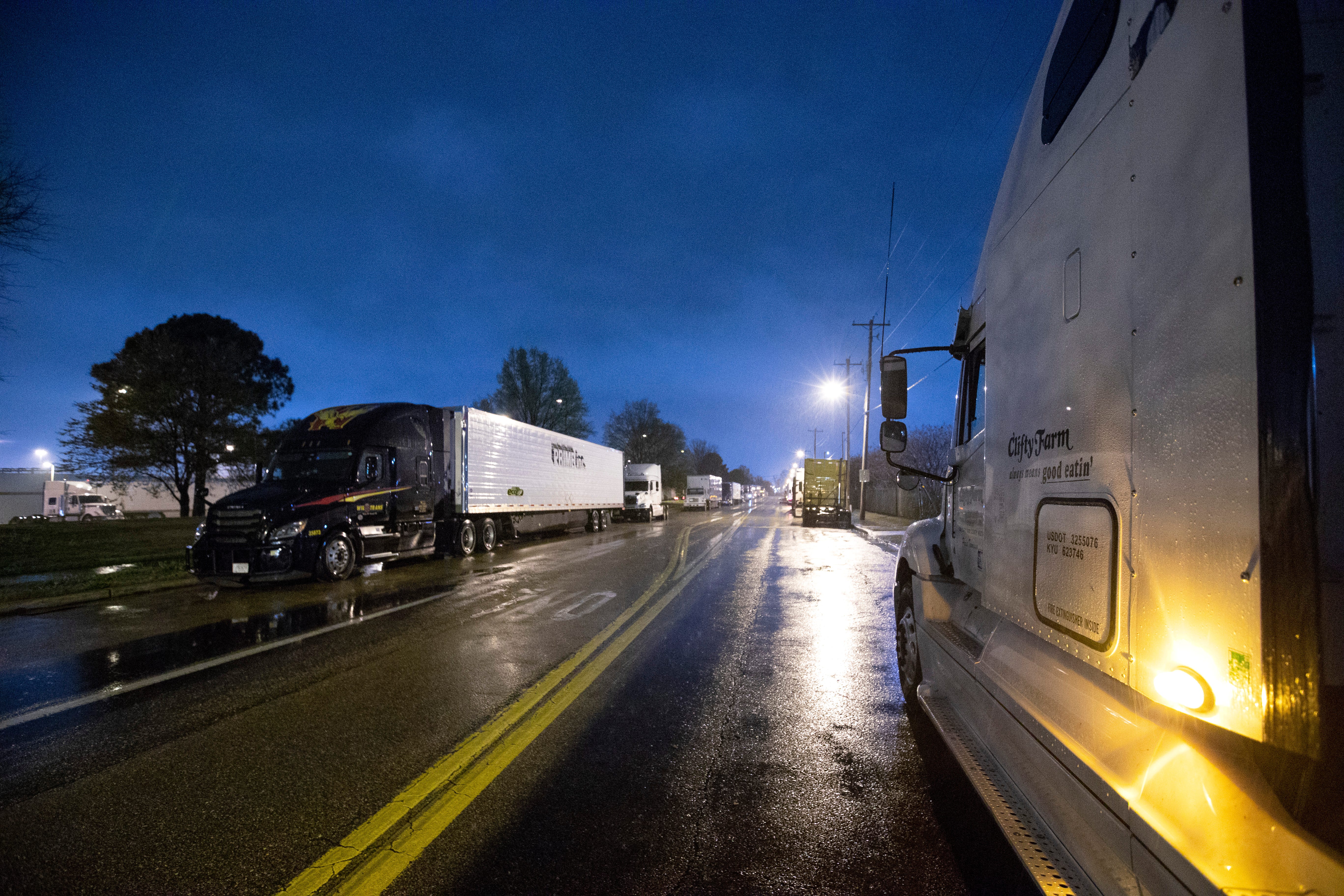 Semi-trucks line up around Kroger supply warehouse on a rain-soaked Tuesday morning where workers are on mandatory overtime, working seven days a week for as much as 16 hour shifts to feed the Mid-South supply chain of grocers as shoppers continue to stock up, cleaning out store shelves around the country. 