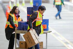 Employees of Eli Lilly prepare to start drive-through testing of Indianapolis-area health-care workers for covid-19, the disease caused by the new coronavirus, at company headquarters in Indianapolis on March 23, 2020. (AP Photo/Michael Conroy)