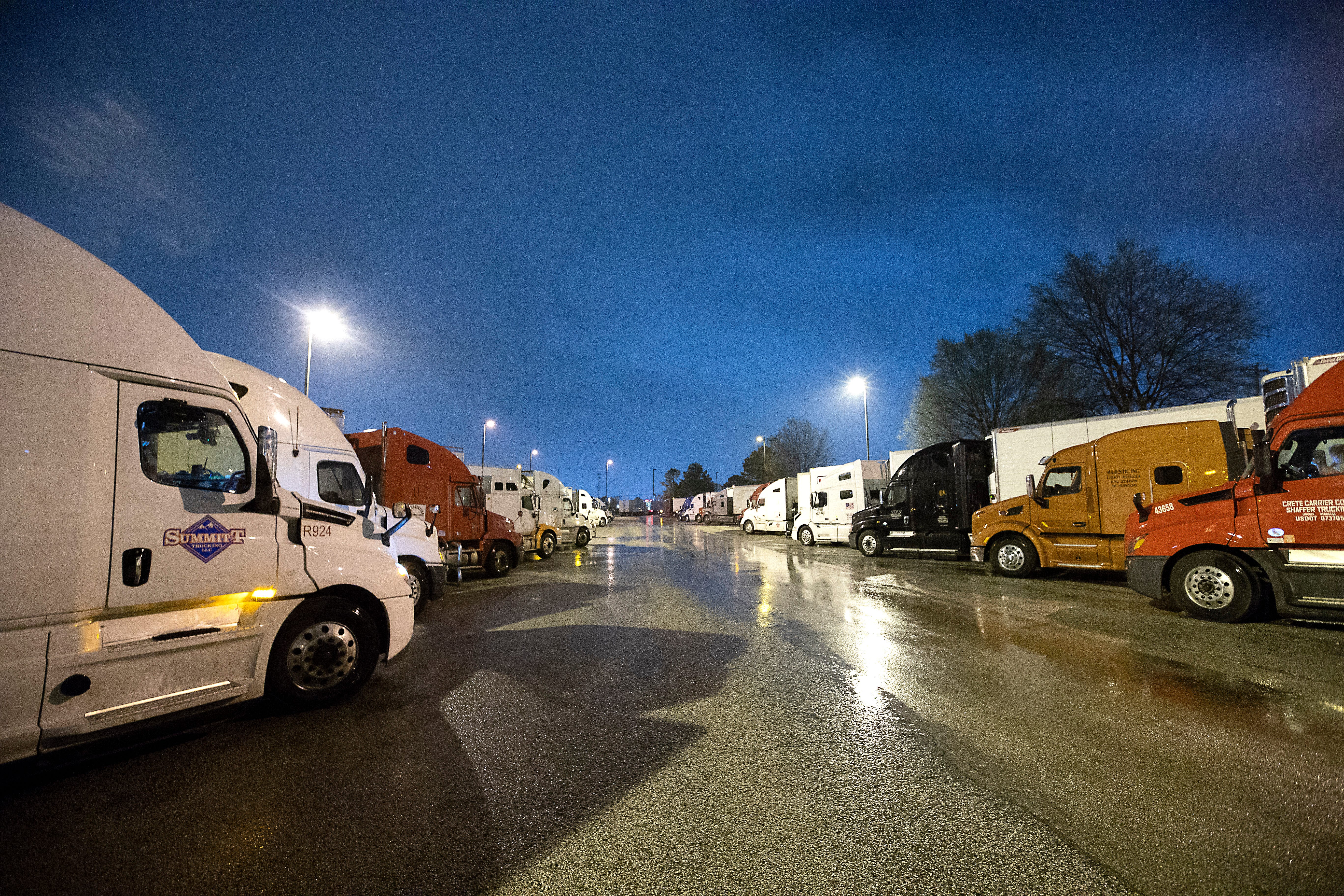 Semi-trucks line up around Kroger supply warehouse on a rain-soaked Tuesday morning where workers are on mandatory overtime, working seven days a week for as much as 16 hour shifts to feed the Mid-South supply chain of grocers as shoppers continue to stock up, cleaning out store shelves around the country. 