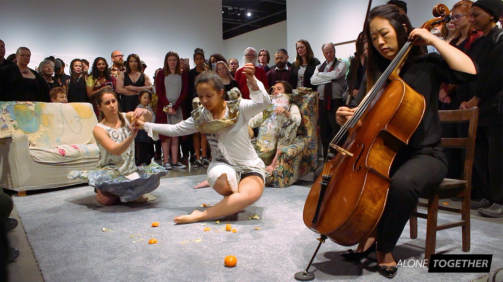 Dancers from NMSU's Kinesiology department engage in an improvisational performance with a cellist.